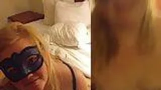Dicke Blondine mit Maske vor der Kamera
